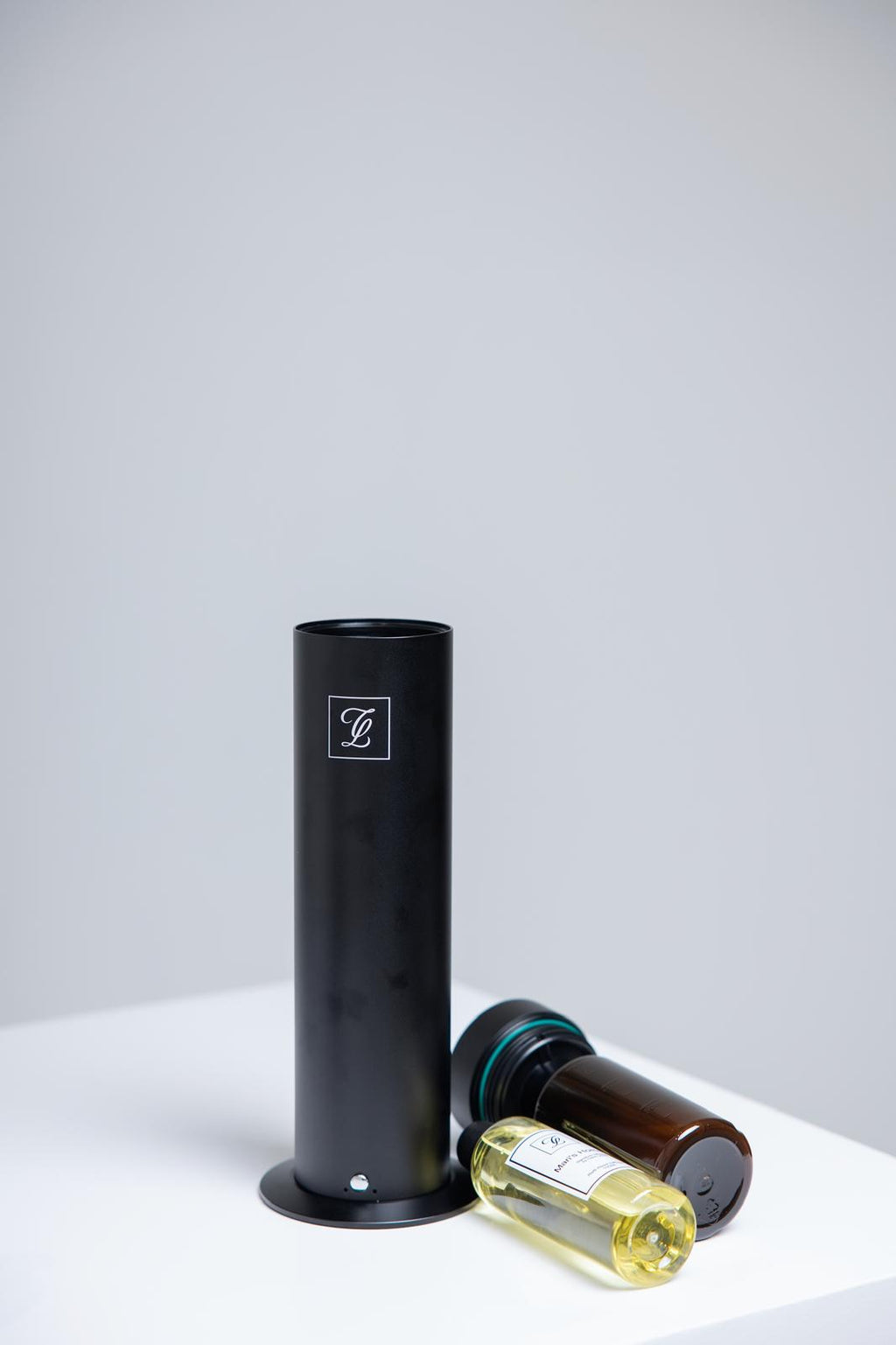 Maison Fragrance Stand Diffuser in Black. Fragrance bottles shown for illustration; inclusion is not confirmed.