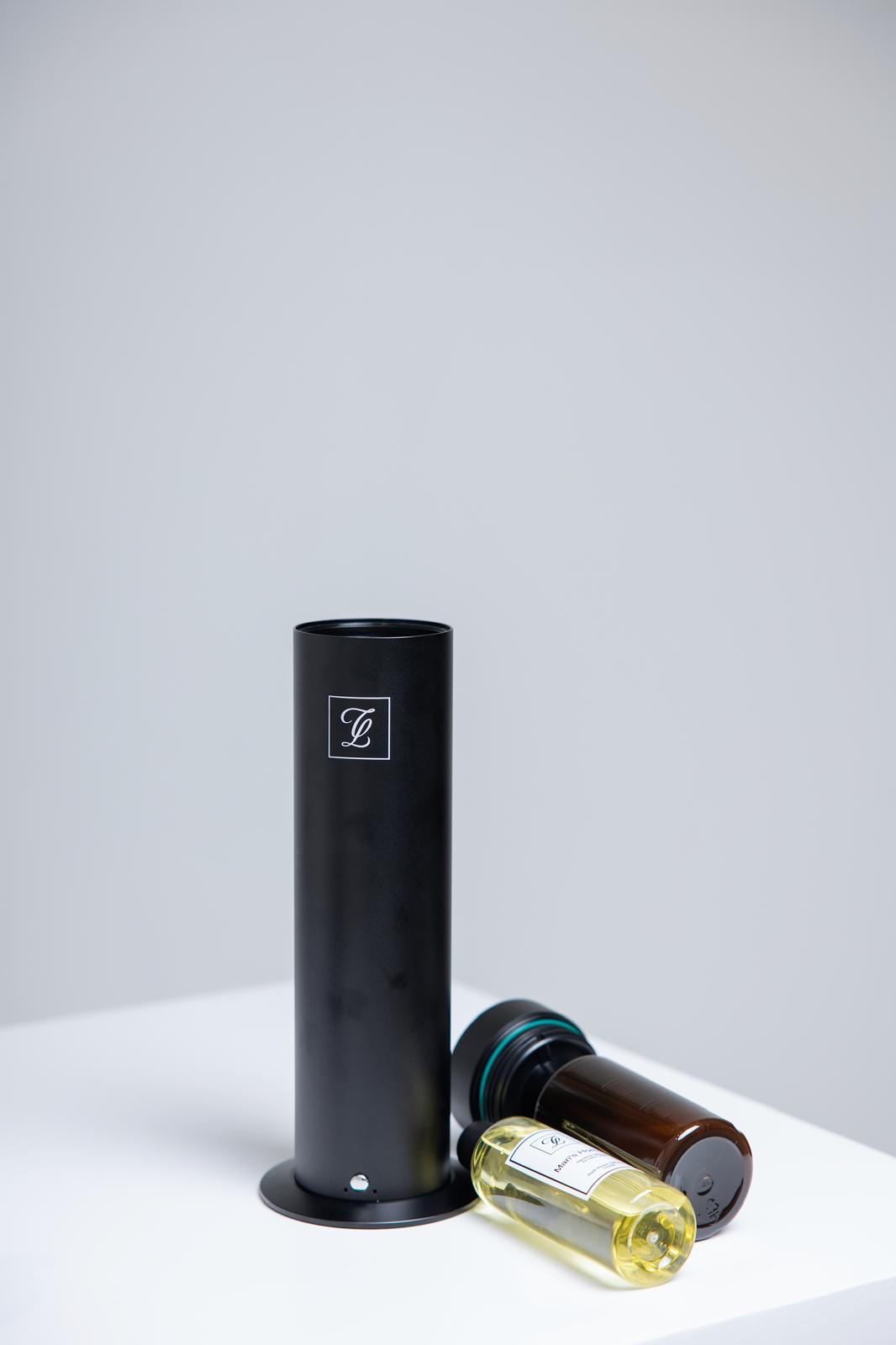 Maison Fragrance Stand Diffuser in Black. Fragrance bottles shown for illustration; inclusion is not confirmed.