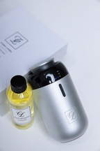 Maison Fragrance Car Diffuser with a silver metallic body and black upper section, shown with the included refill.