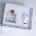 Maison Fragrance Ceramic Diffuser with a gold-capped glass bottle and white ceramic flower in a white presentation box.