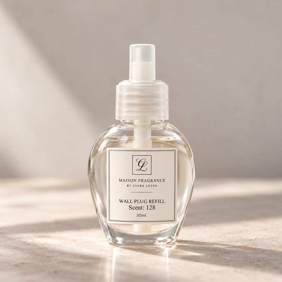 Maison Fragrance by Ciara Lessa Wall Plug Refill, Scent 128, 30 ml, in a rounded clear bottle with a translucent cap.