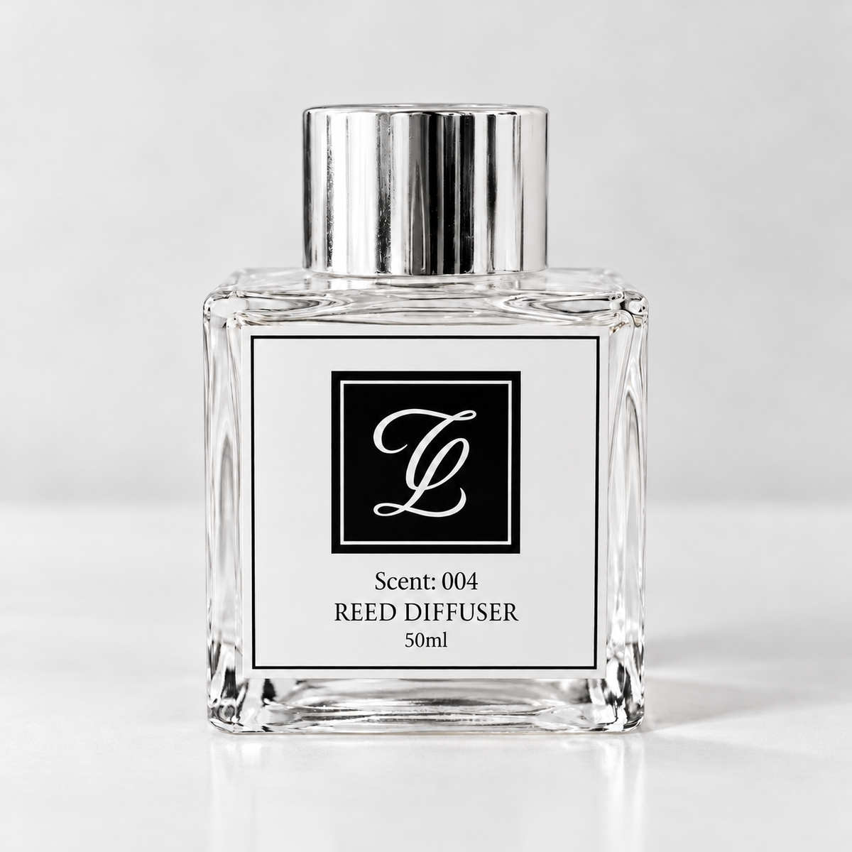 Maison Fragrance Scent 004 Reed Diffuser, 50ml, compact square clear glass bottle with silver cap on a light neutral background.